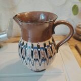 Pitcher with ethnic decorations