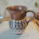 Pitcher with ethnic decorations