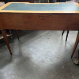 Louis XVI style marquetry desk. The top is decorated with green leather.