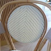 Pair of Parisian bistro chairs from Maison Louis Drucker in light Manila rattan.