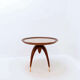 Round Art Deco side table in wood with curved legs and brass feet.