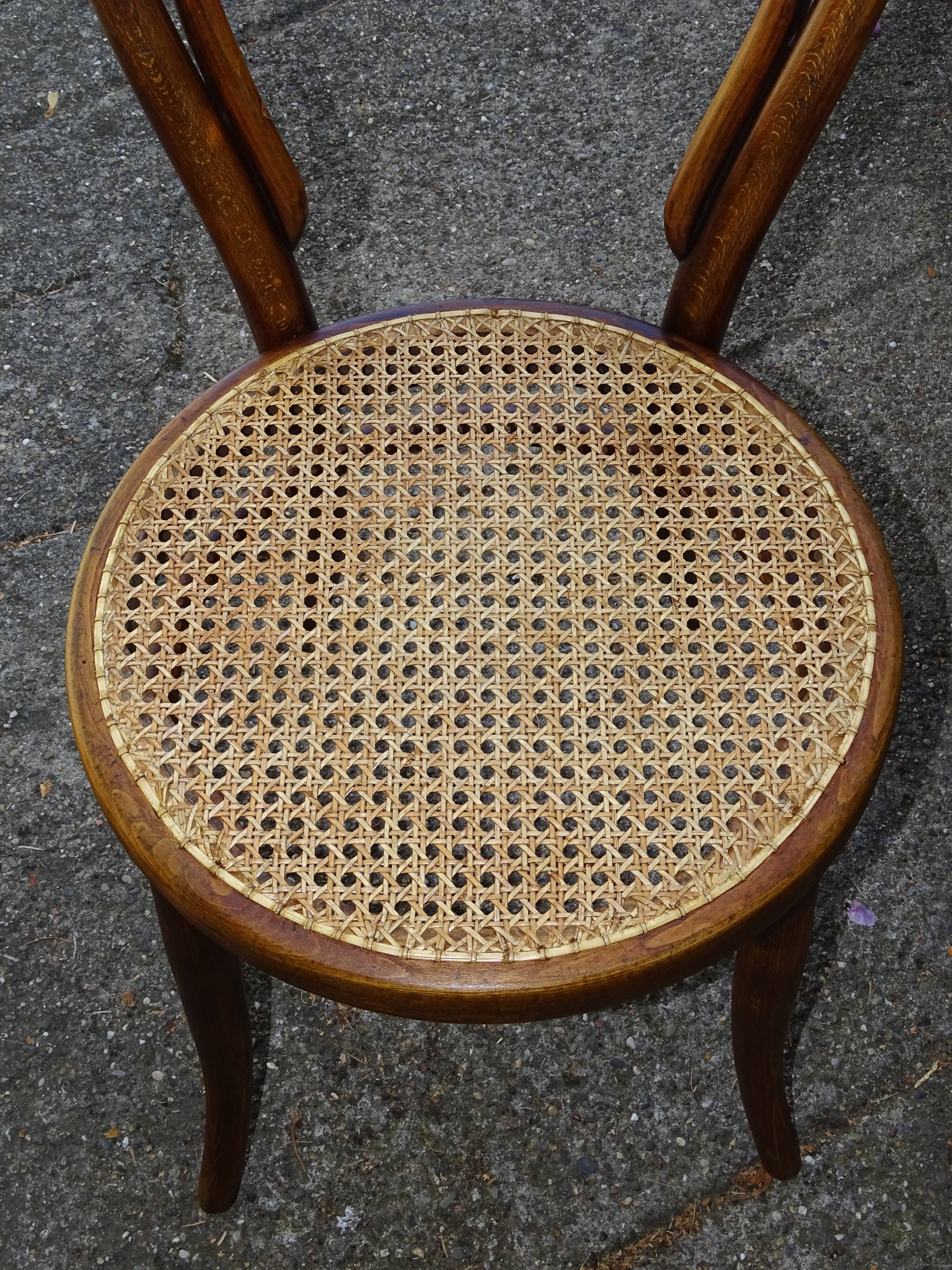 Two Turpe canned Bistro 1900 color rosewood chairs