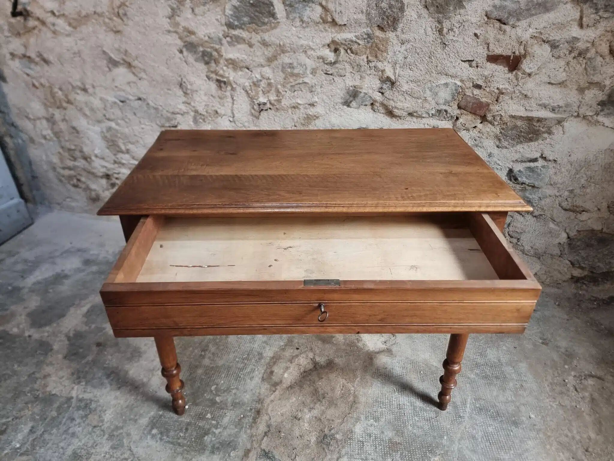 Antique French writing table in walnut with a drawer, circa 1900.