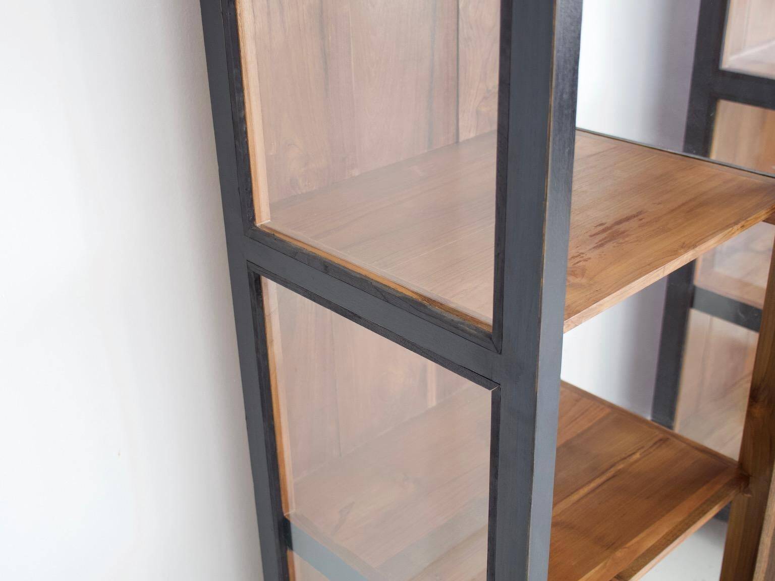 Pair of black wooden display cabinets with glass doors.