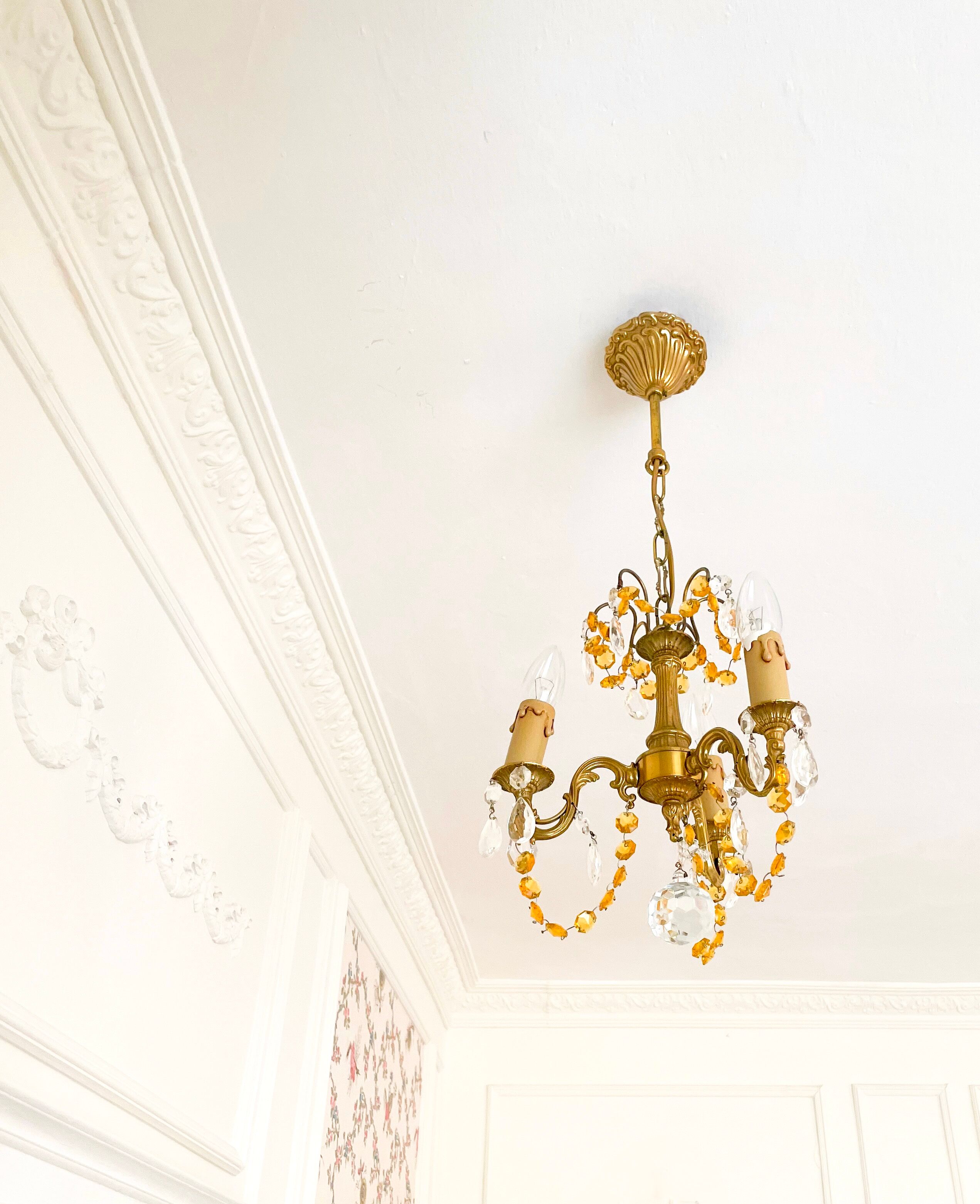 Small vintage brass chandelier with amber crystal pendants.