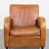 Characteristic sheepskin design armchair in beautiful warm cognac colours