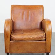 Characteristic sheepskin design armchair in beautiful warm cognac colours