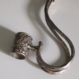 Large decanter with large glass neck and silver metal handle.