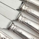 12 antique silver-plated knives with acanthus shell decoration and stainless steel blades.