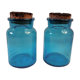 pair of apothecary vials in blue glass jar