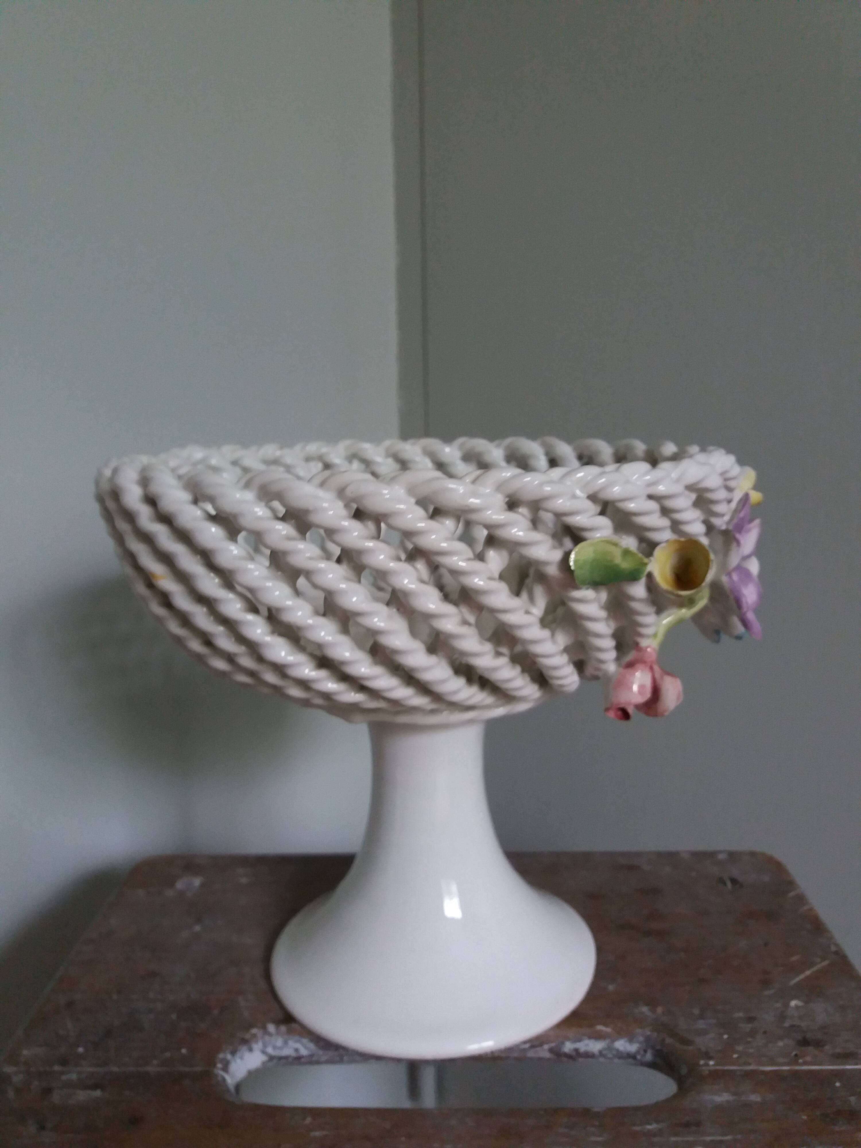 Cup on woven ceramic base with slip flowers