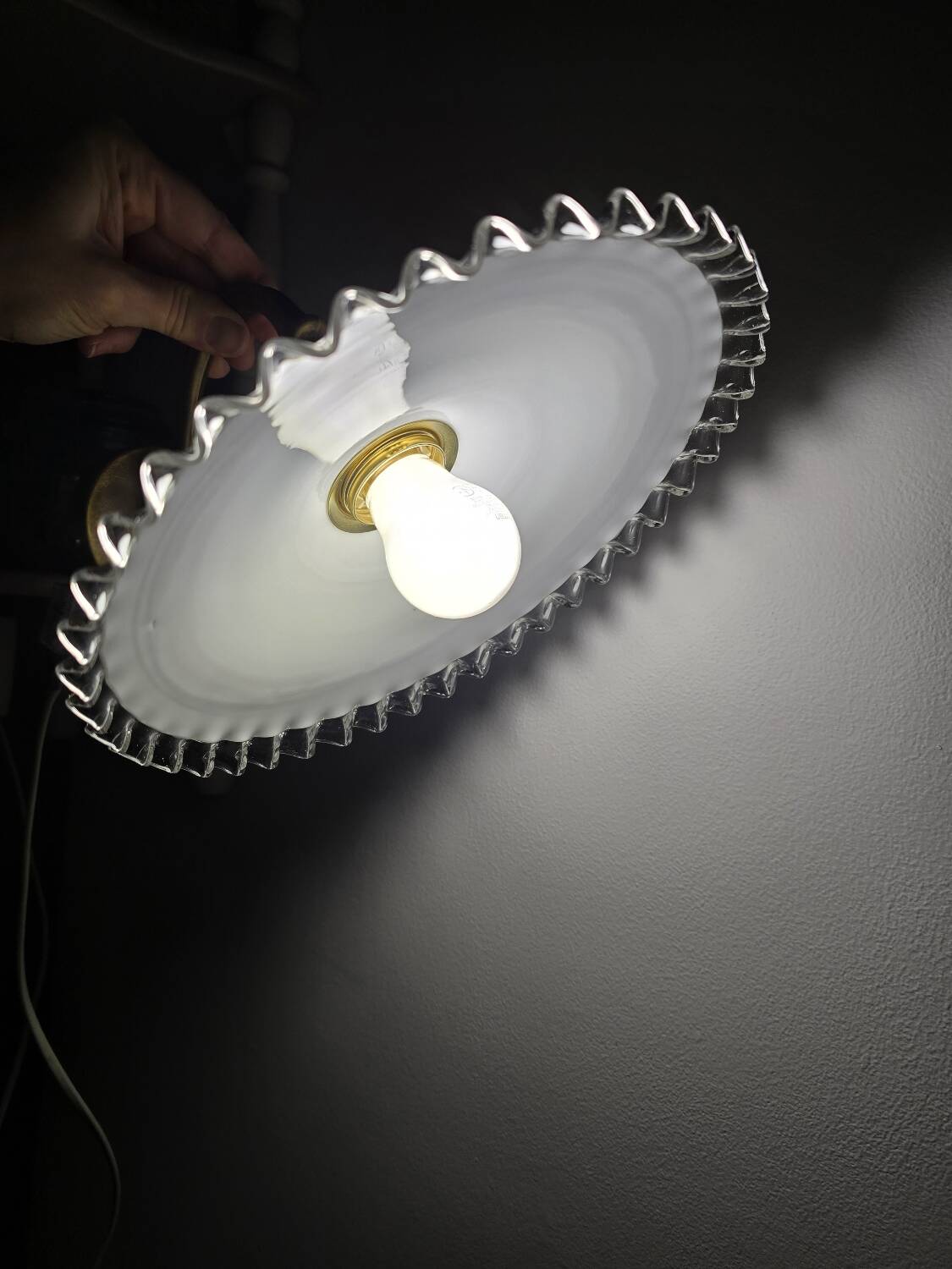 Wall sconces with scalloped opaline lampshades.