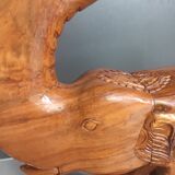 Decorative rocking elephant in carved exotic wood.