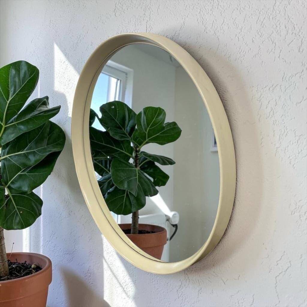 Beige vintage round mirror in a space style / wall mirror