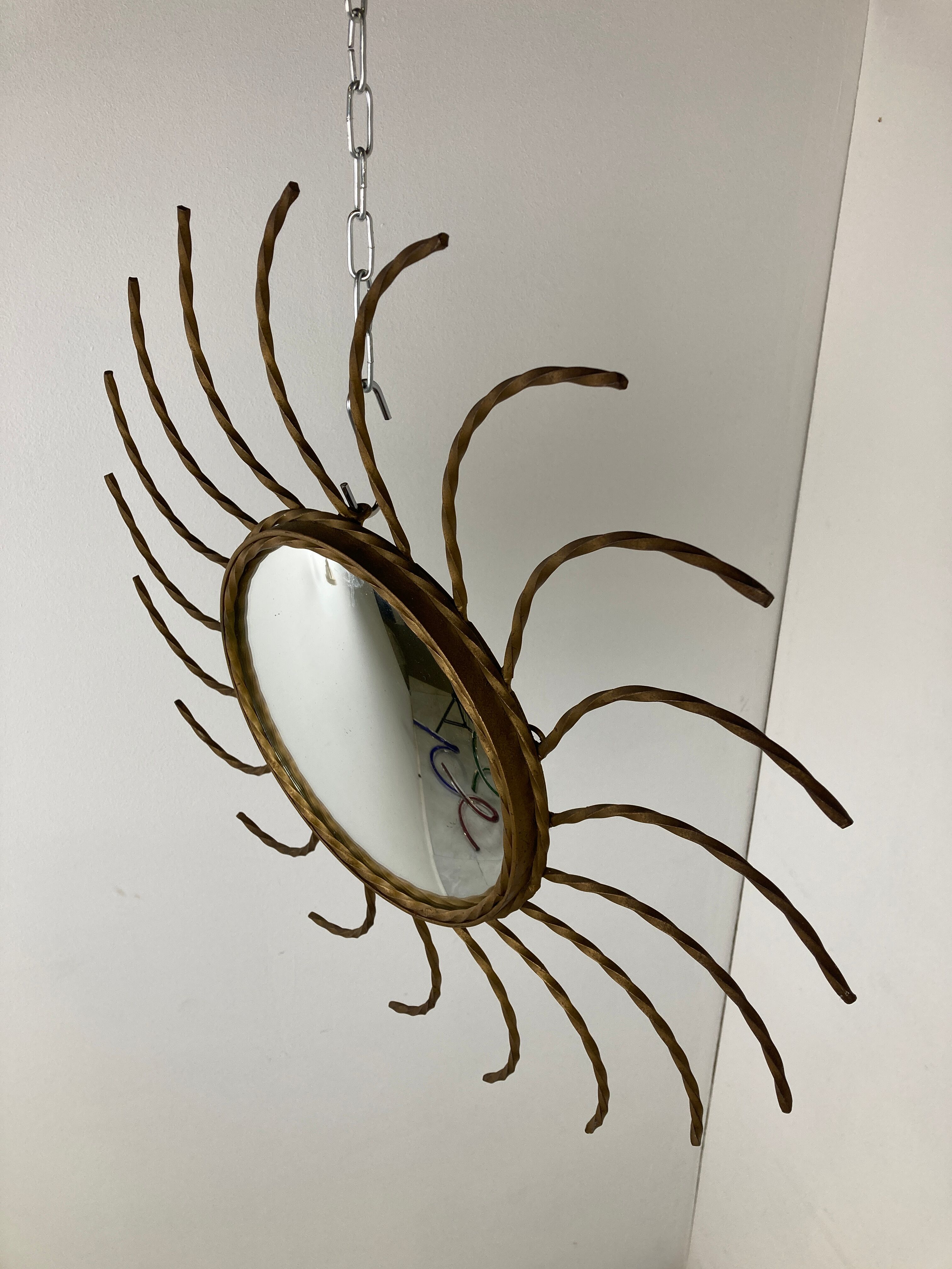 Mid century gold sunburst mirror with convex glass.