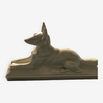 Vintage ceramic lying dog on base