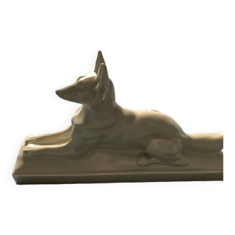 Vintage ceramic lying dog on base