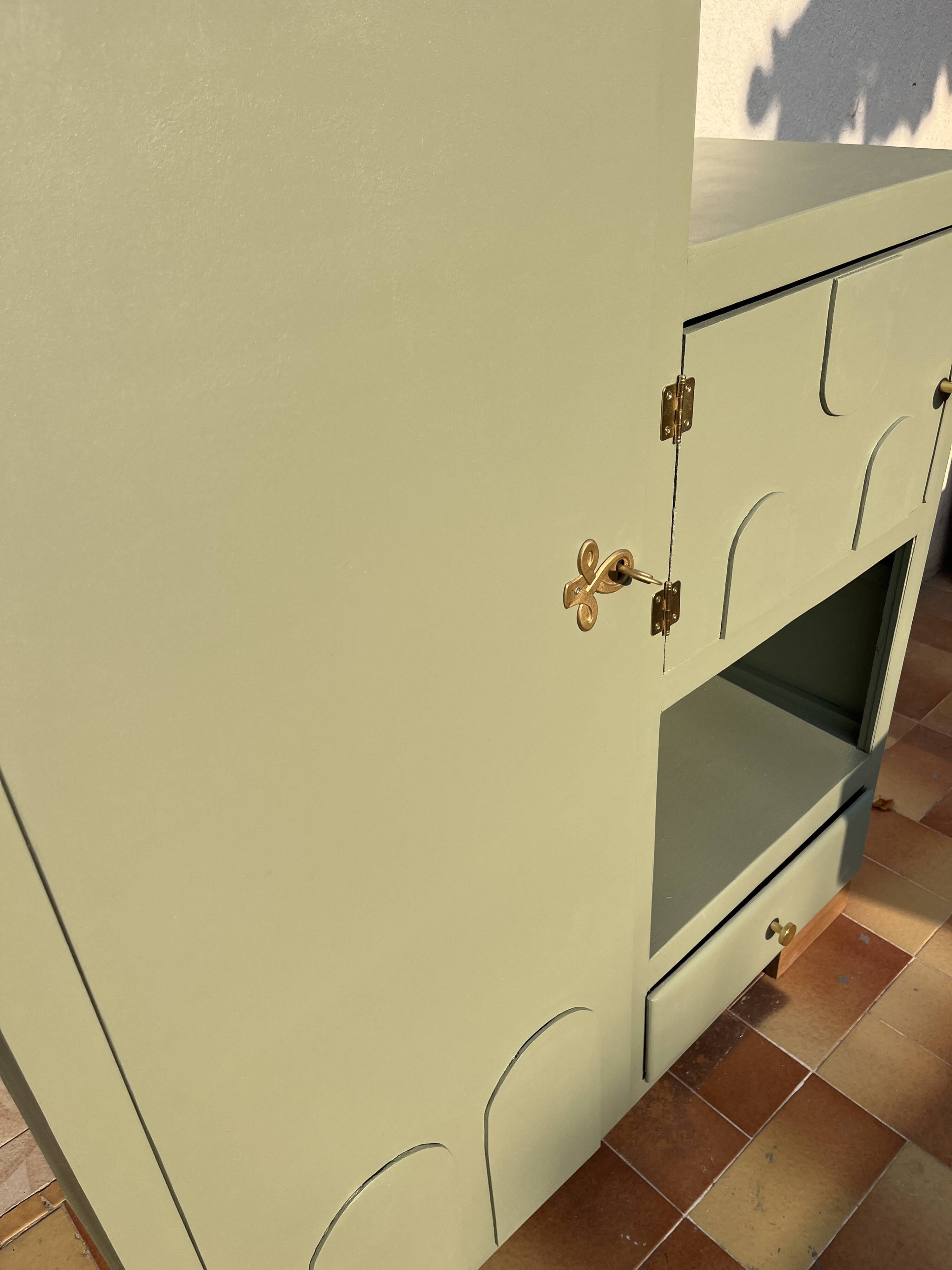 Asymmetrical vintage wardrobe painted in green.