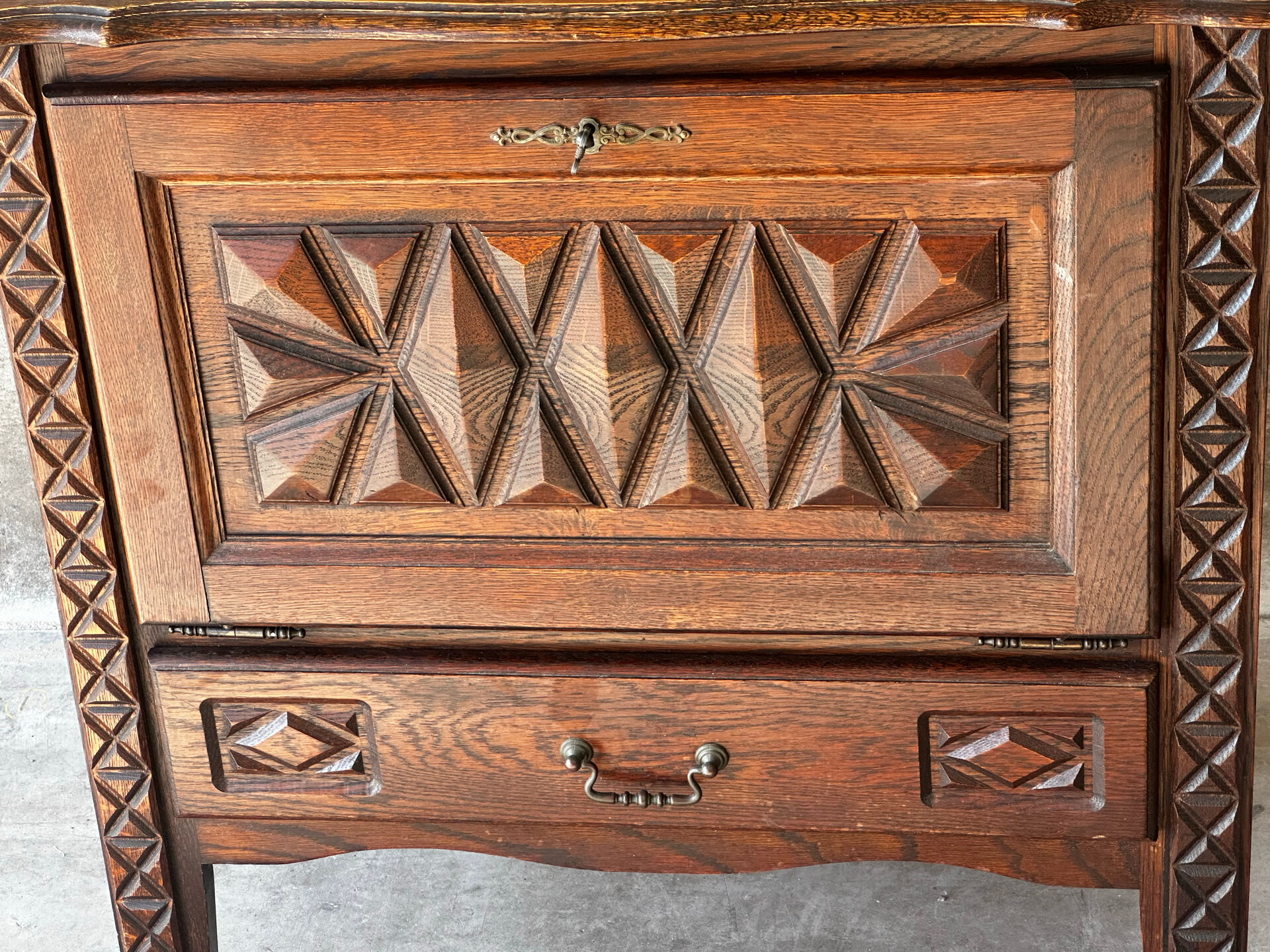 Small storage cabinet in carved oak – circa 1930