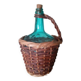 Glass bottle in its wicker dress