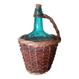 Glass bottle in its wicker dress