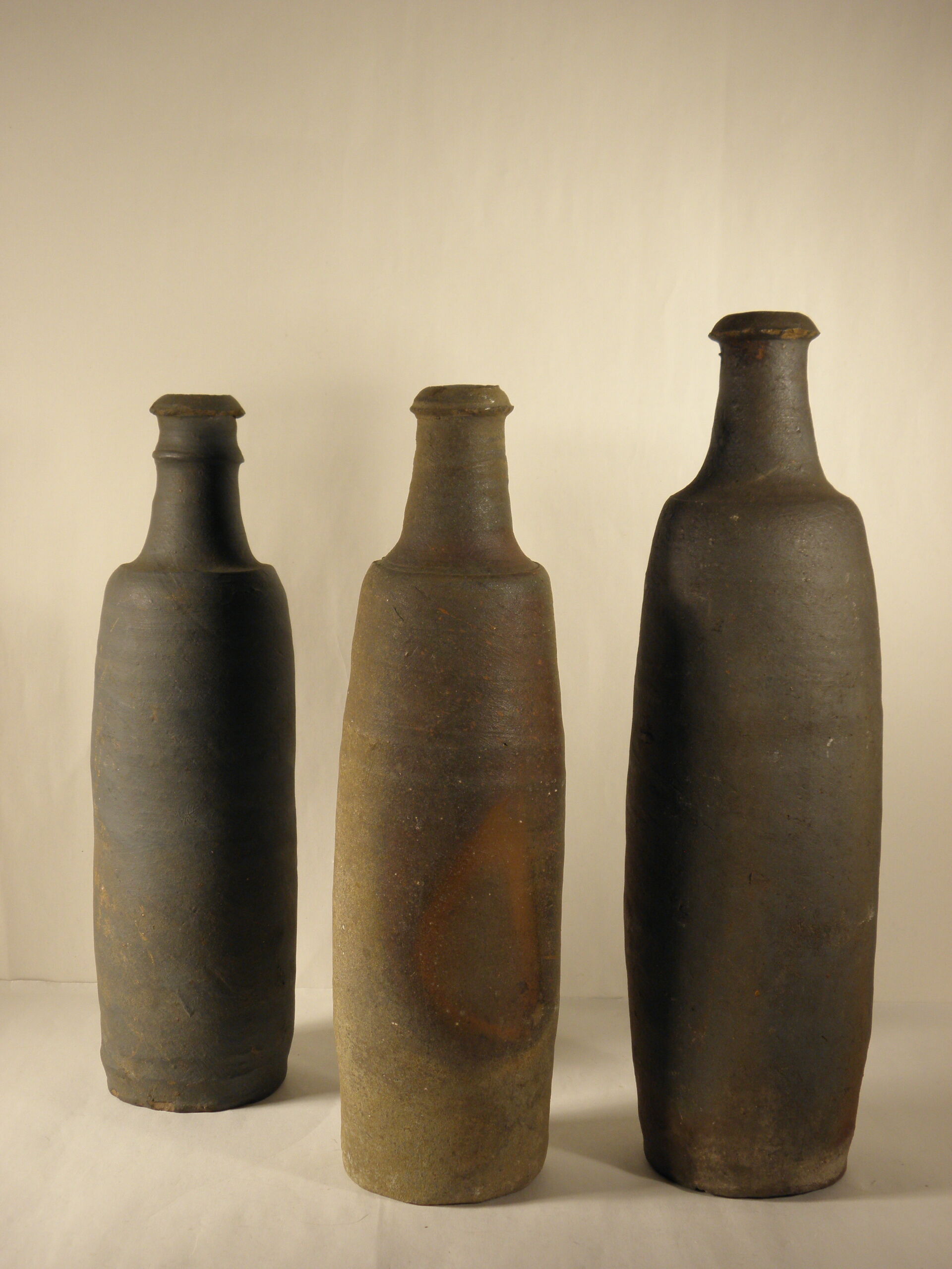 Three old sandstone bottles