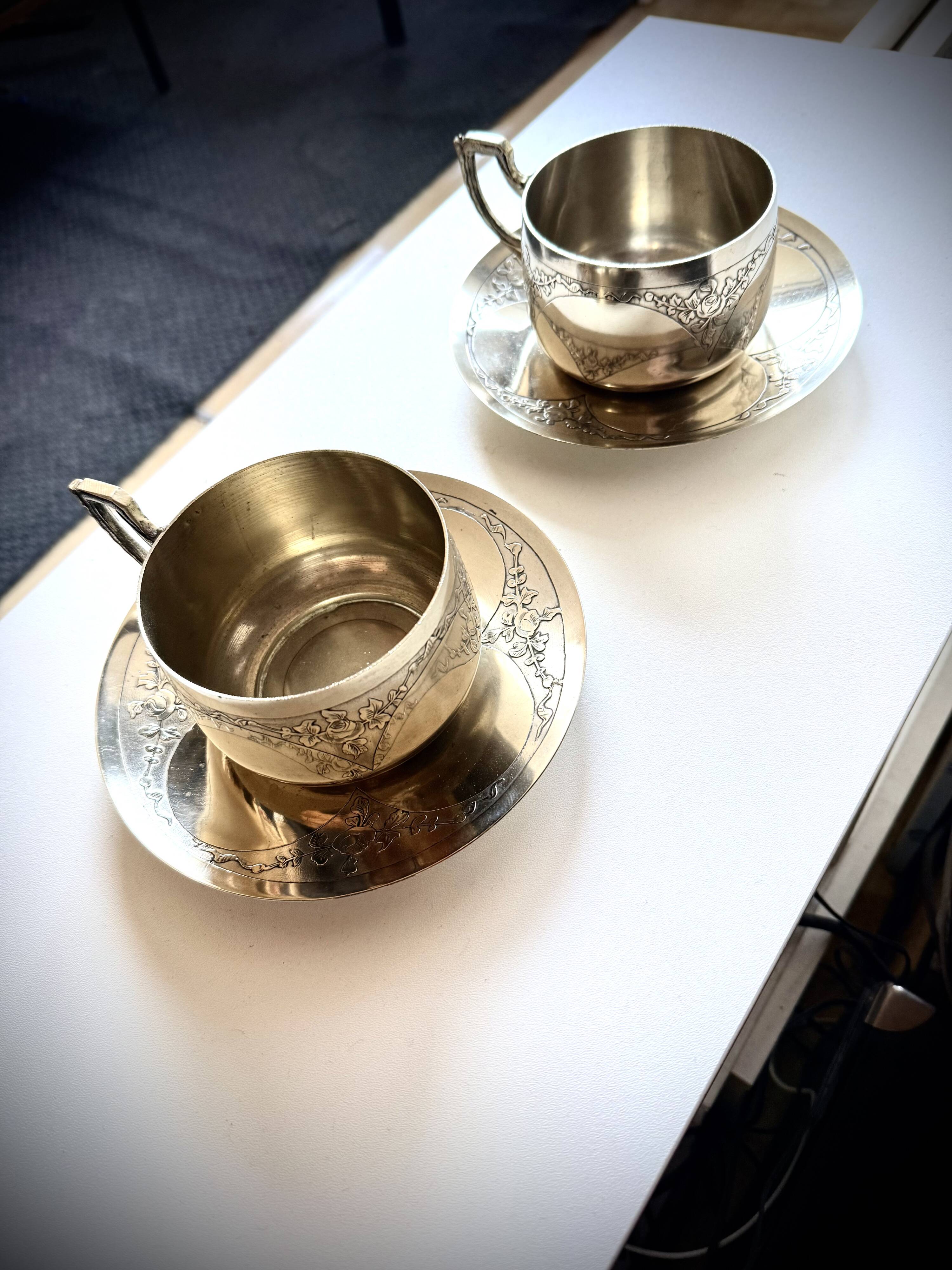 Set of 2 cups with silver-plated saucers, 19th century.