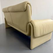 Two-seater designer sofa De Sede DS-2011 in cream leather with adjustable backrest.