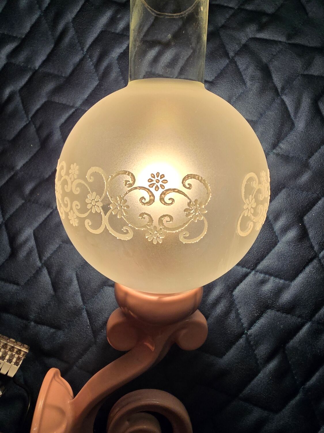 Original wall lights in pink enamelled cast iron with frosted glass globes.