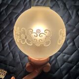 Original wall lights in pink enamelled cast iron with frosted glass globes.