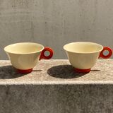Two old orange handle cups