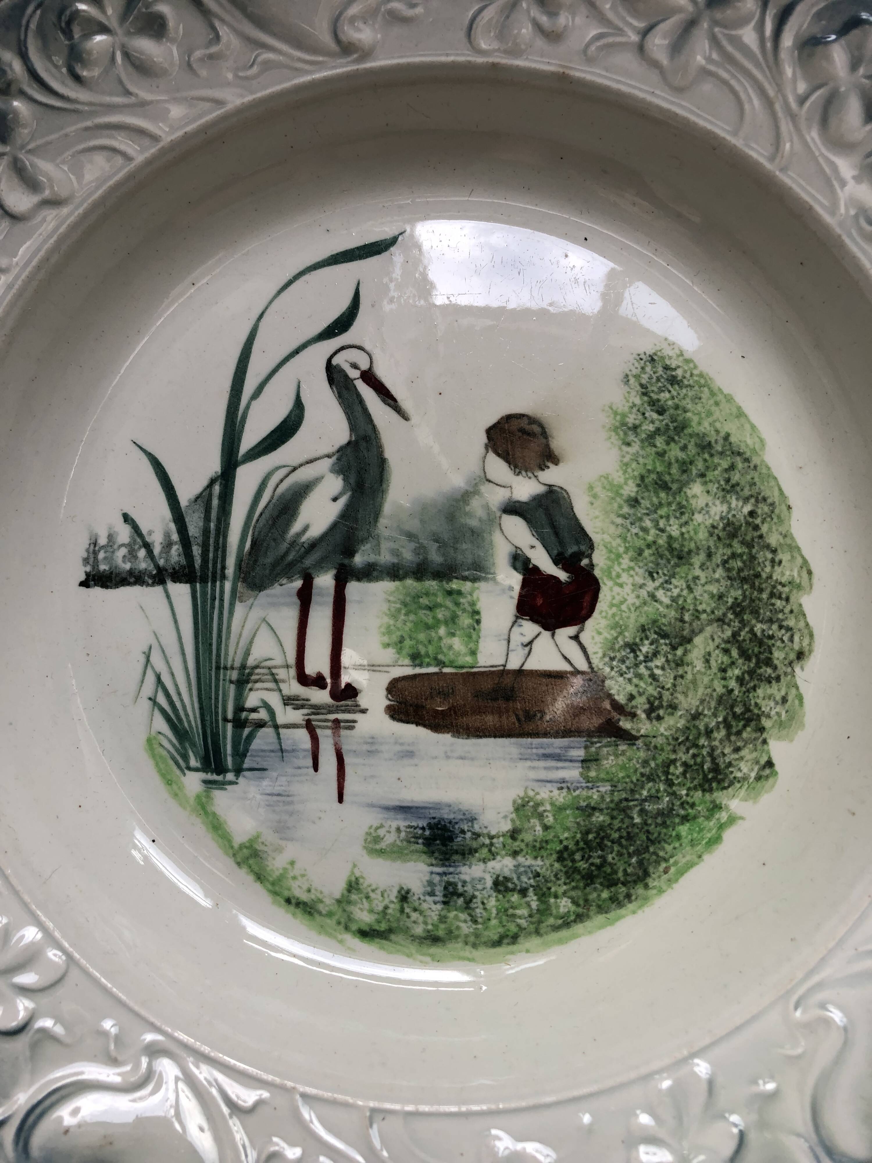 Vintage hollow serving dish with a decoration: marsh landscape.