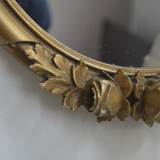 Oval mirror in gilded wood