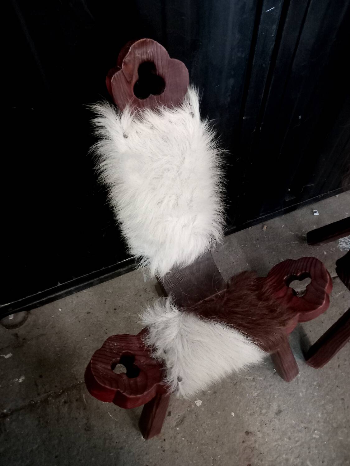 Pair of brutalist tripod chairs in wood and cowhide