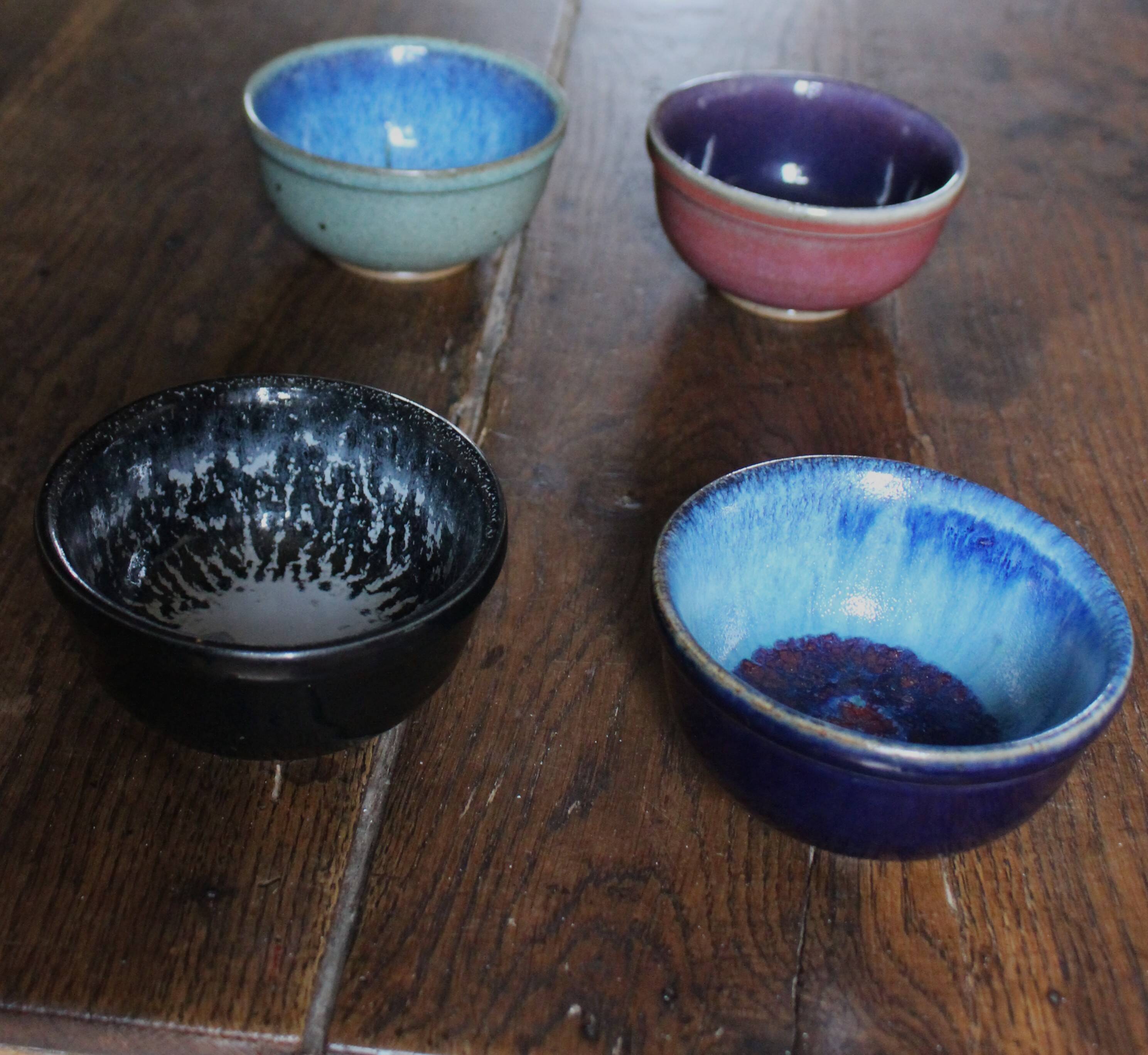 A set of 4 pottery bowls in coloured glaze.