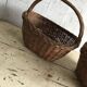 Set of 2 brown wicker baskets from the 1960s — decorative weaving and double handles.