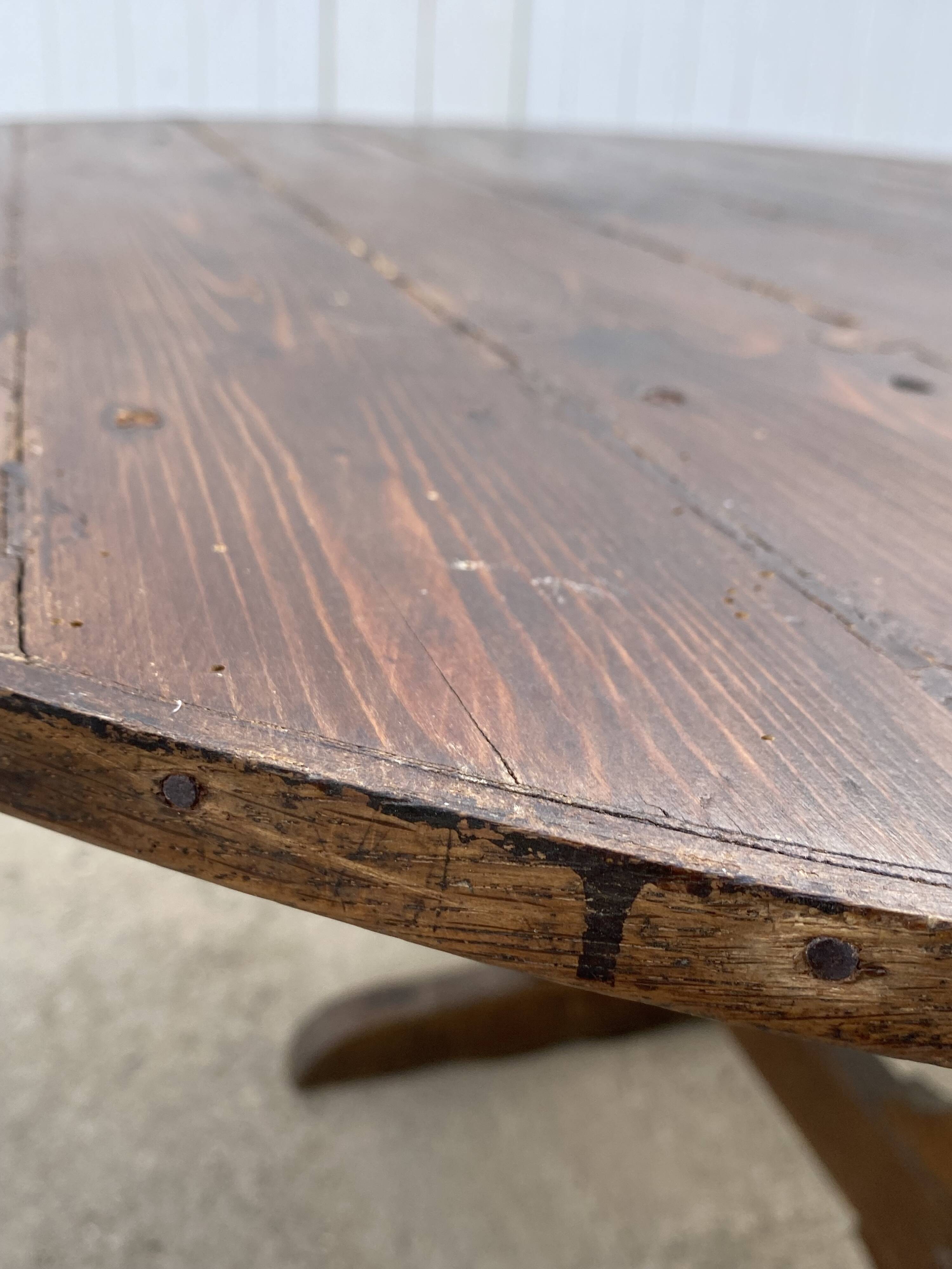 Old folding round winemaker's table with a tilting top.