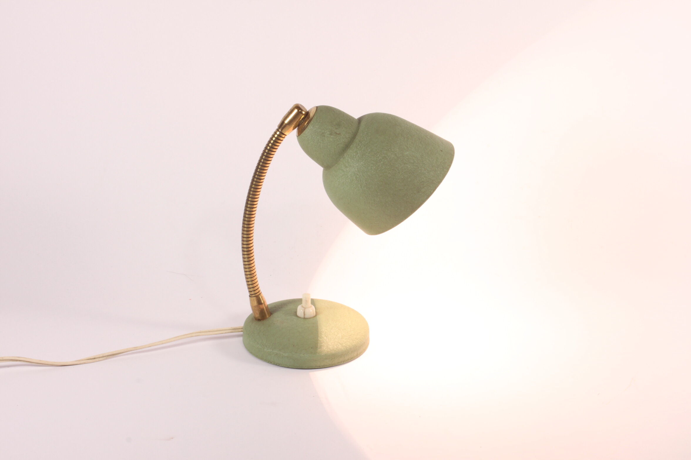 Flexible brass and green metal bedside lamp, 1950s.