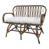 Rattan bench with white cushion