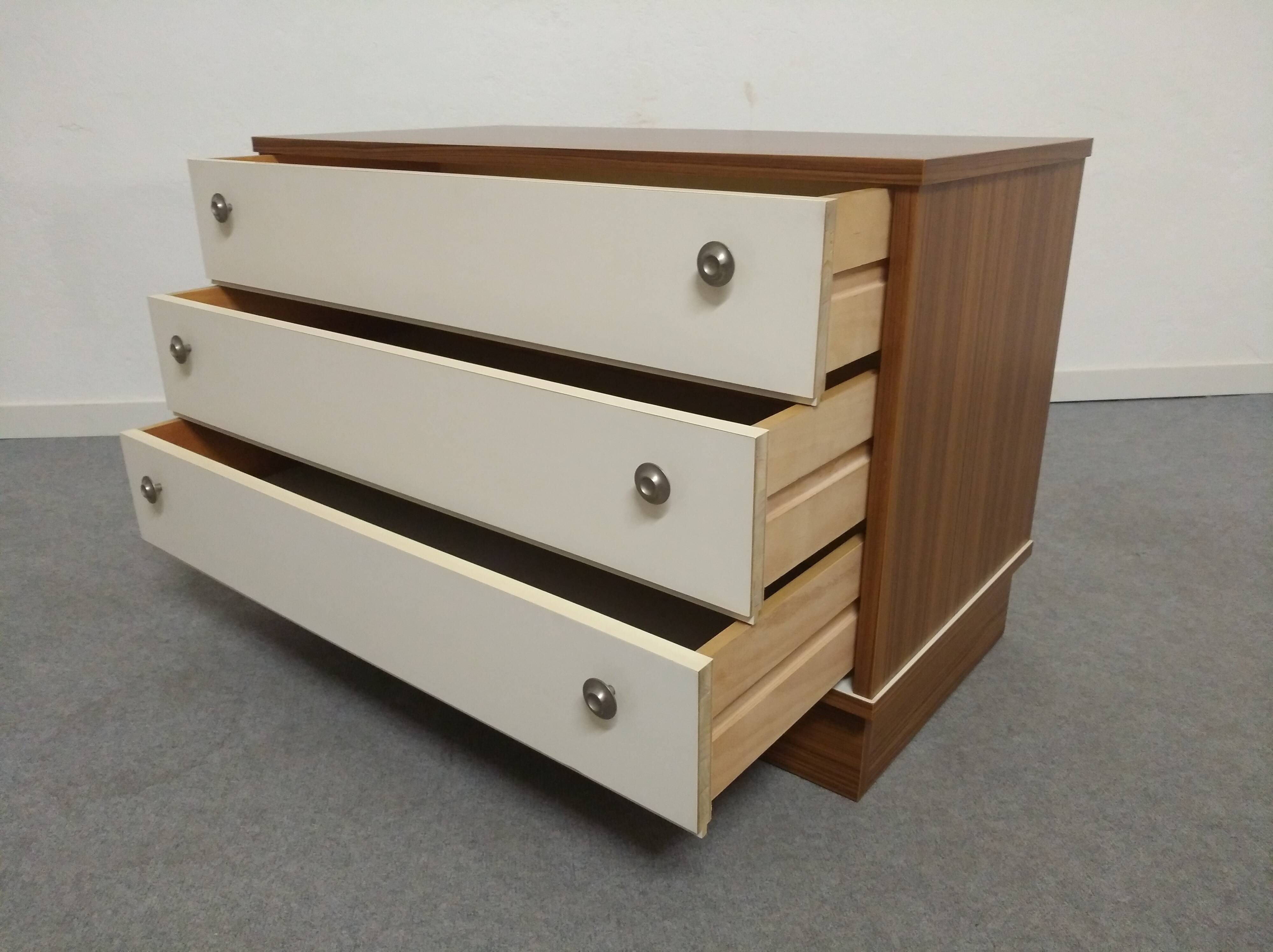 Low chest of drawers with 3 drawers in mahogany and white satin, France circa 1980.