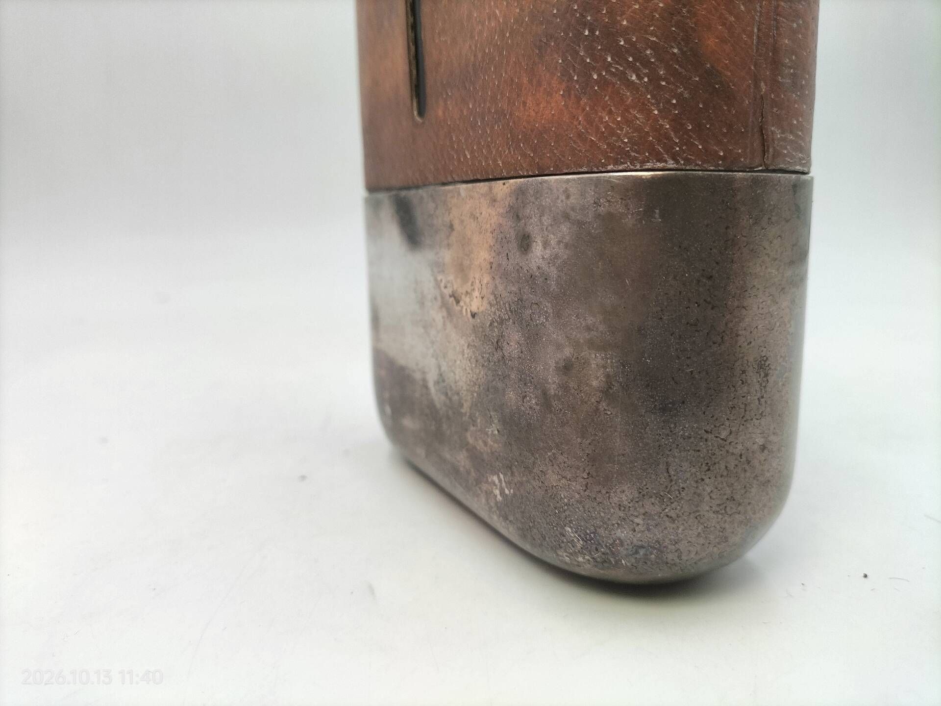 Silver-plated metal flask with leather and glass