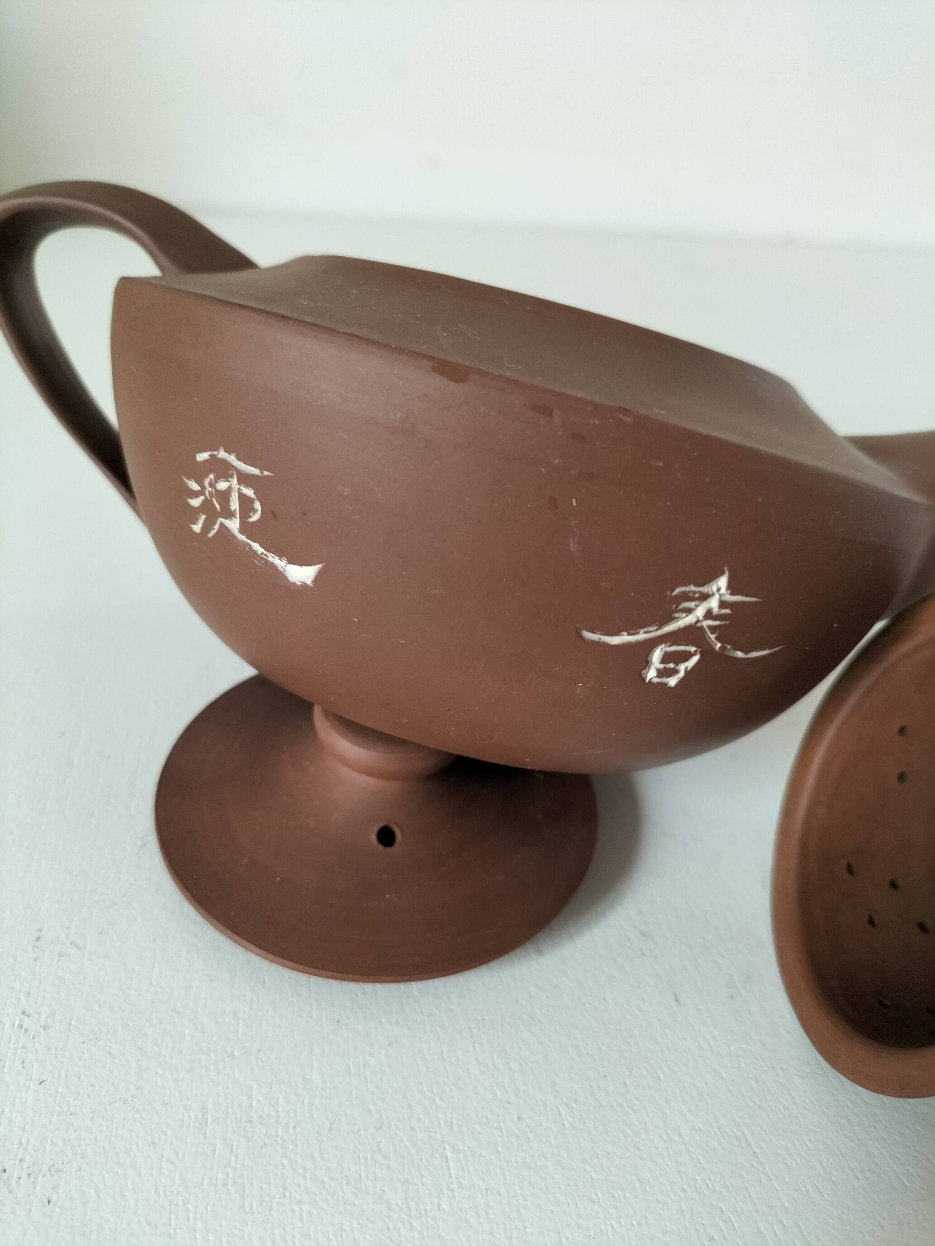 Japanese teapot in red clay engraved with integrated filter.
