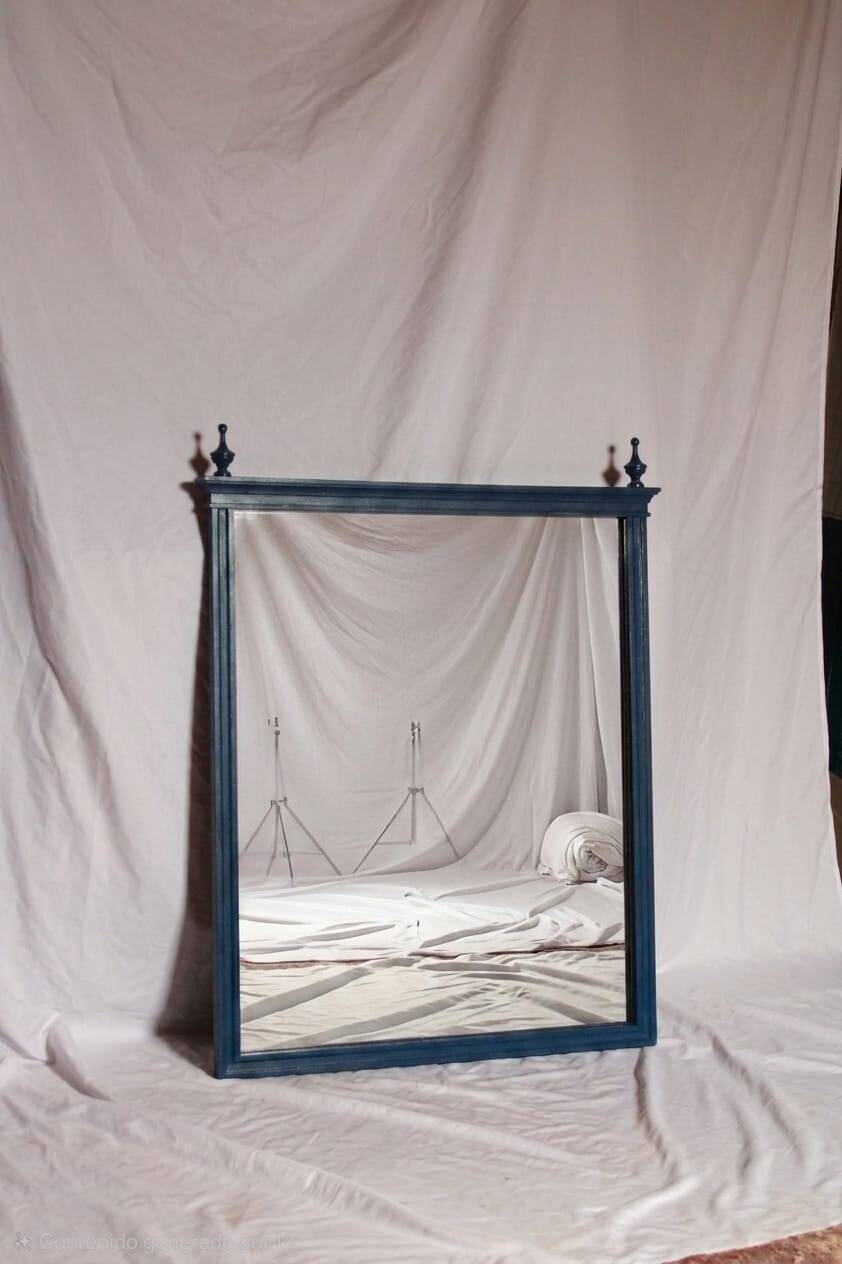 Restored vintage mirror in navy blue, Louis XVI style.