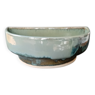 Glazed stoneware jardinière in almond green, semi-circular, signed.