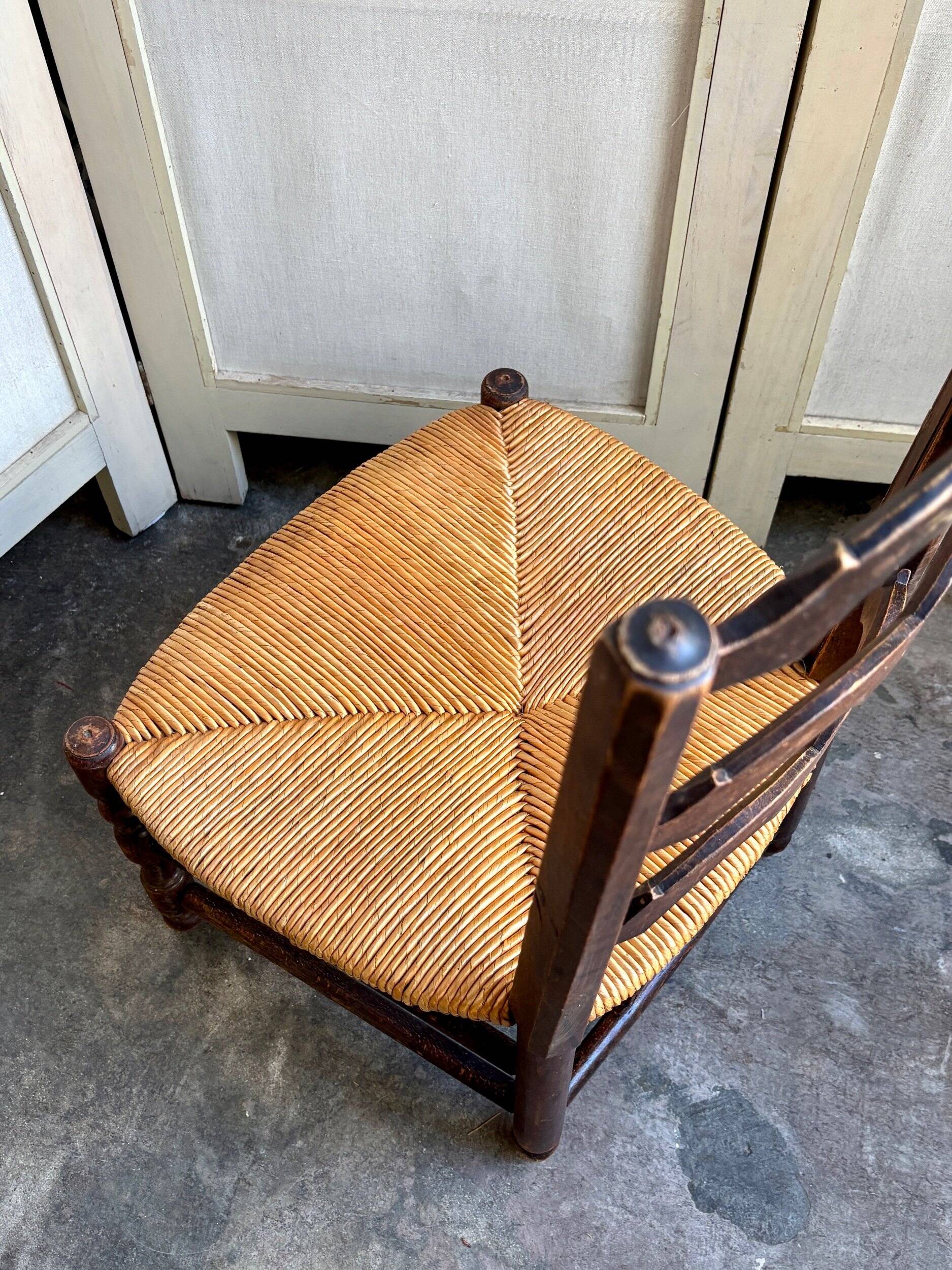 Low Provencal chair in dark wood and woven straw