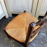 Low Provencal chair in dark wood and woven straw