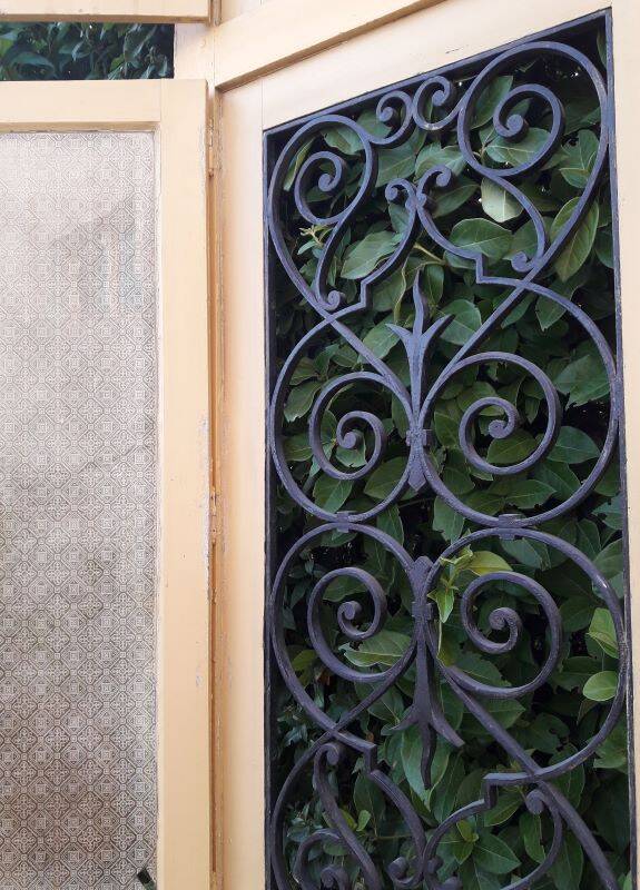 19th century double arched entrance door in oak with grilles and old glass