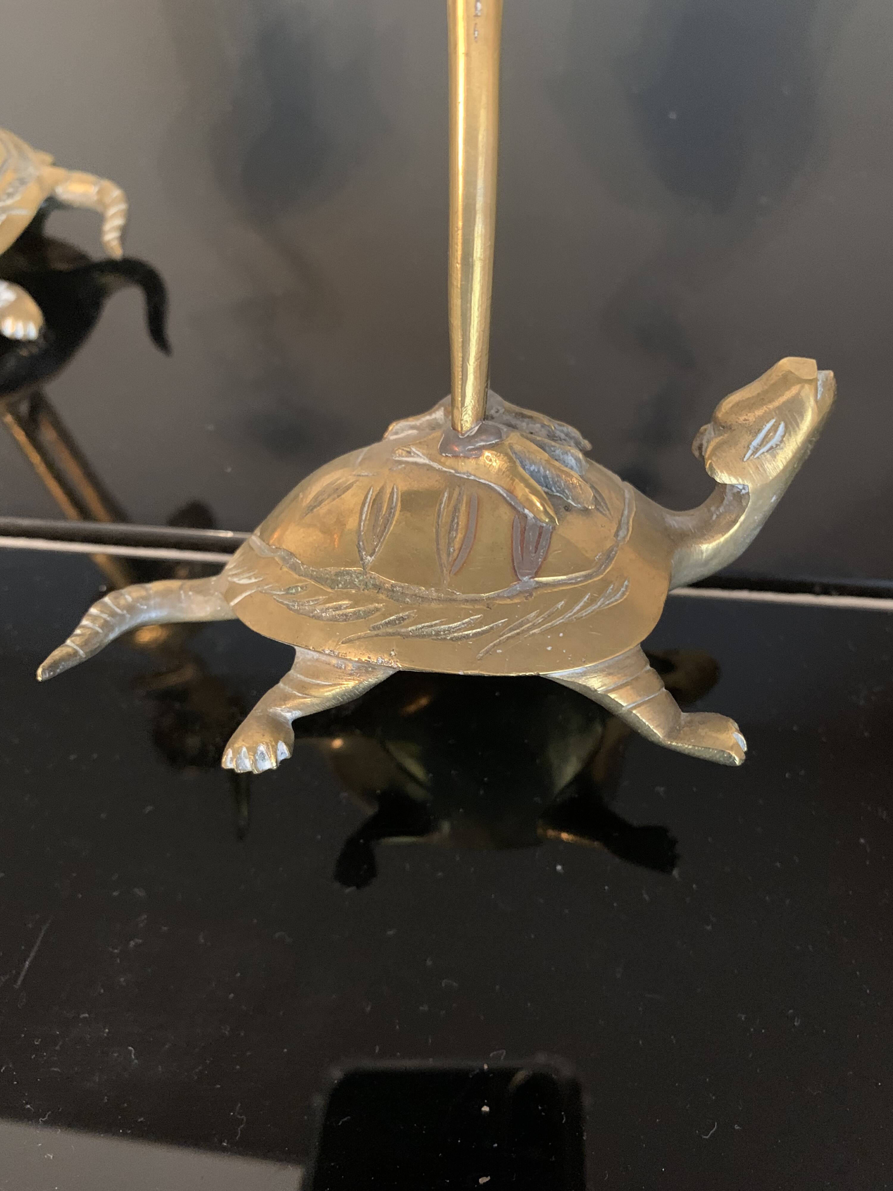 Pair of chiseled and gilded bronze candlesticks depicting perched waders