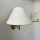 Pair of vintage adjustable wall lights, brass and beige fabric, France, 1970