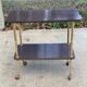 Brown rosewood rolling table with gold legs